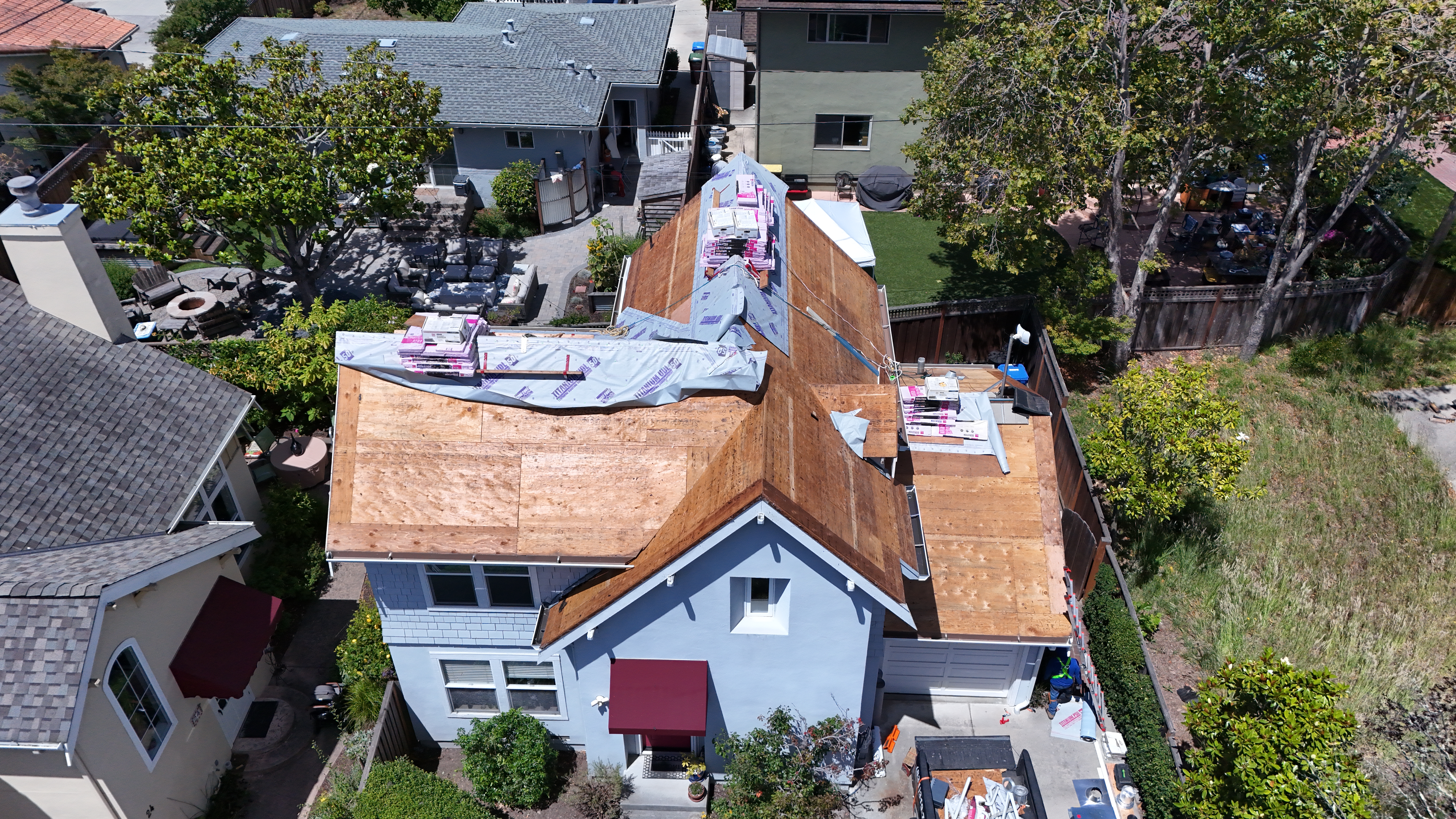 Roof deck exposed and new sheathing staged – installation day aerial view